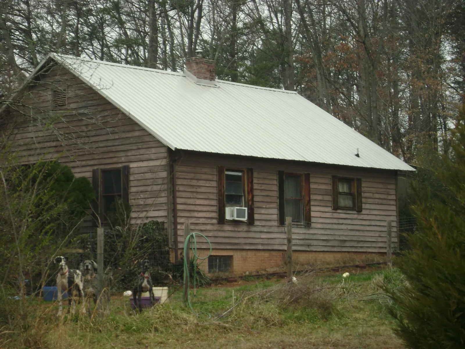 White metal roof on an old wood sided farmhouse, from a Metal Roof Installation job in Hollis